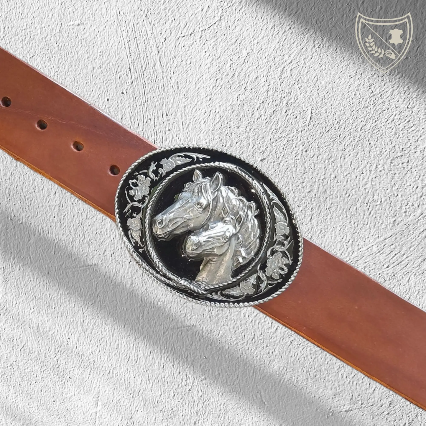 Ceinture cuir végétal couleur havana avec boucle de ceinture West Spirit, ovale argentée, fond noir laqué, chevaux sculptés et motifs floraux, style western, fermoir fiable pour confort et maintien. 